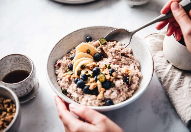 woman-making-healthy-breakfast-in-kitchen-1249206154-d7a7546af41b4cf2a03b13dda5421b58